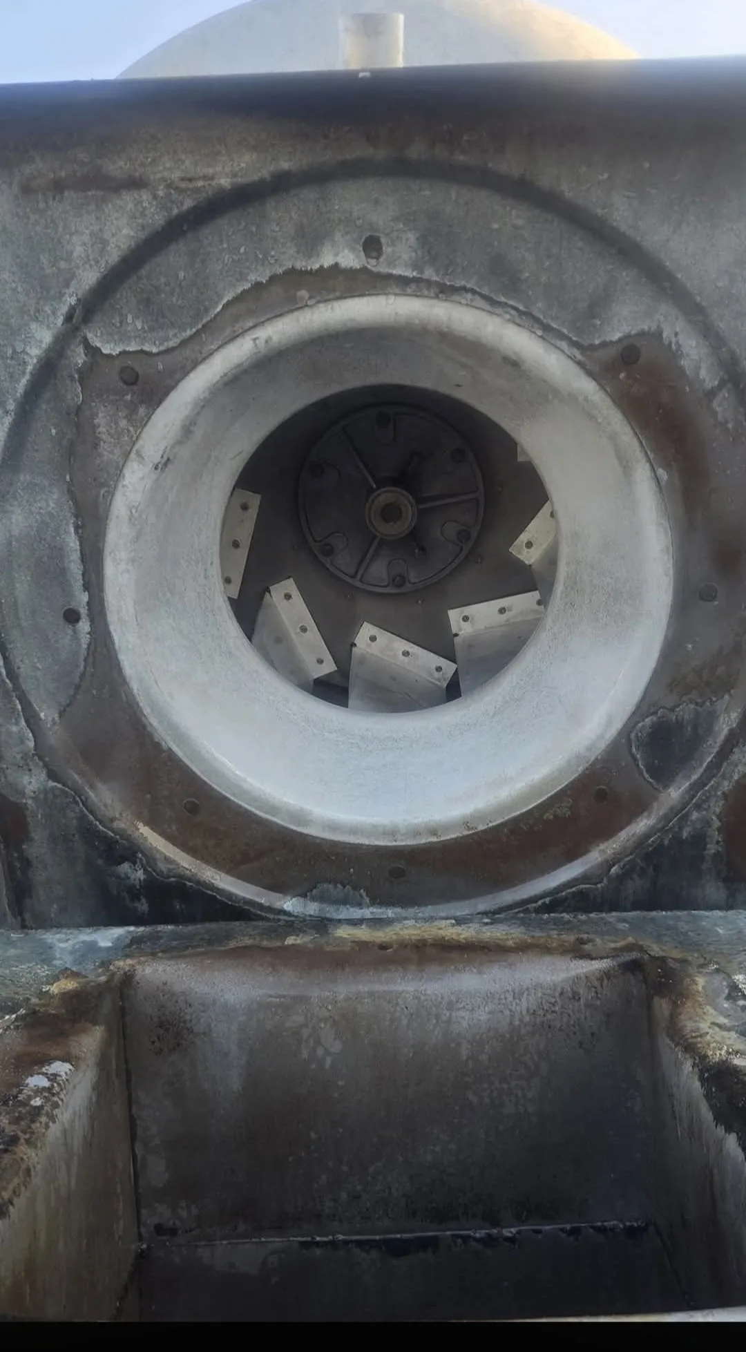 Commercial rooftop exhaust fan wheel after cleaning showing clean metal blades