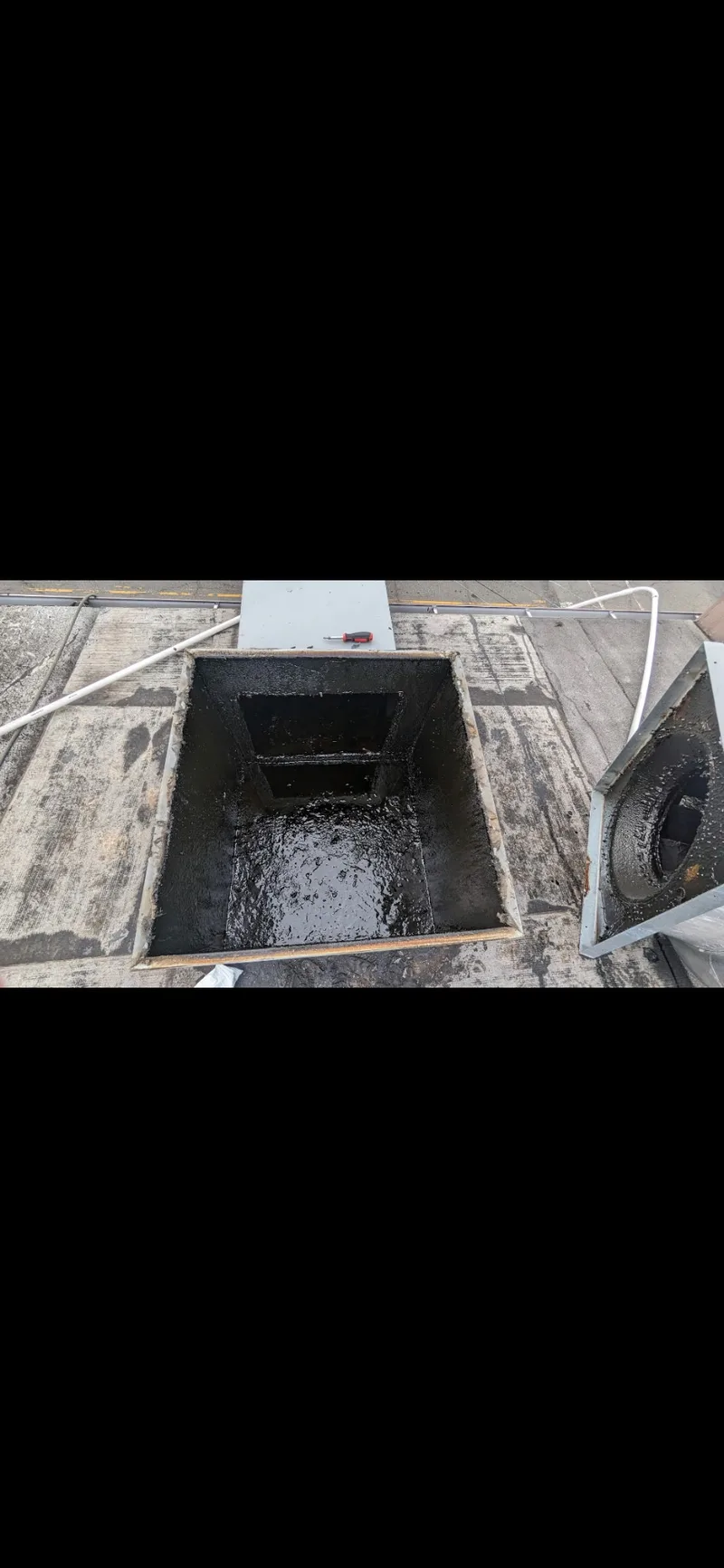 Duct box before cleaning — thick grease buildup inside