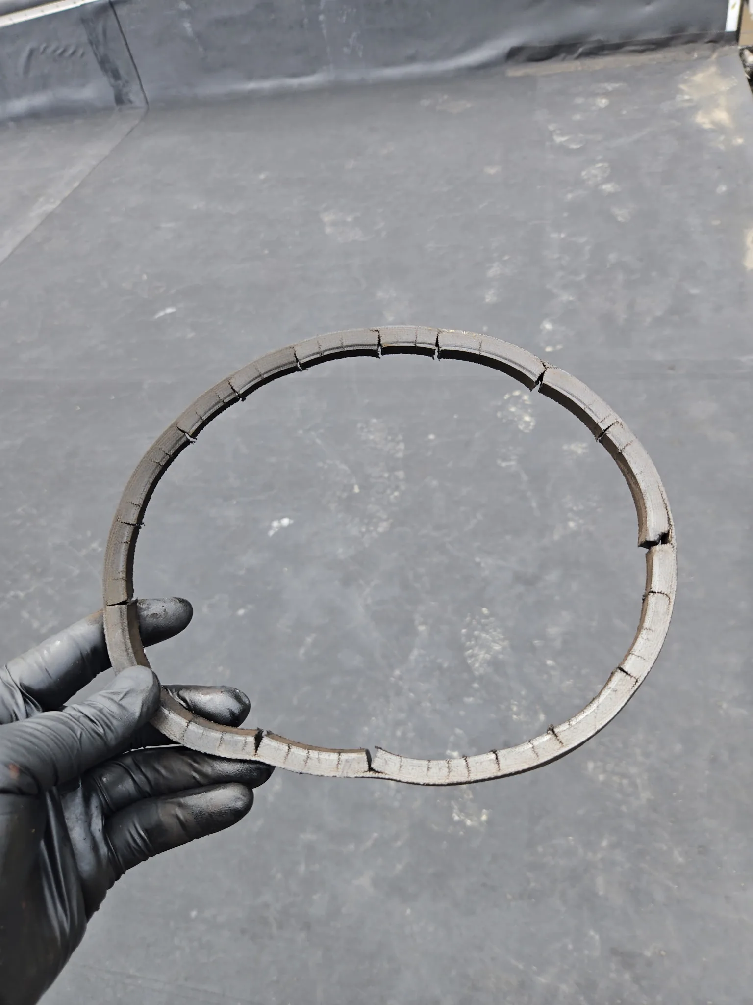 Worn exhaust fan drive belt removed from commercial rooftop unit