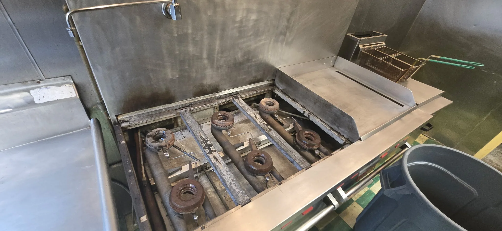 Commercial range interior cleaned with burner still assembled in place