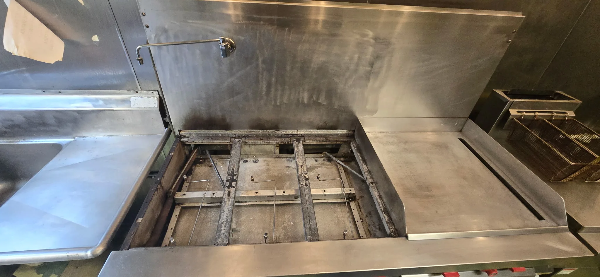 Commercial range interior cleaned with burner removed showing clean frame and base